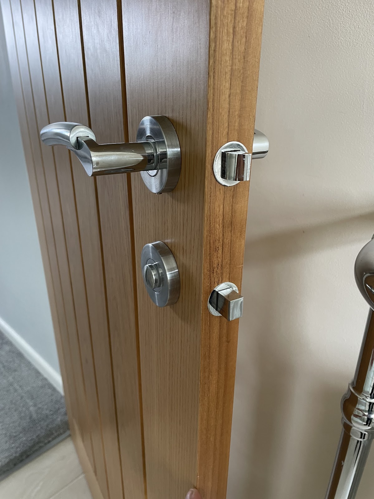 Timber door with chrome lever handle and deadbolt